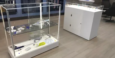 A display case with two glass cases on the floor.