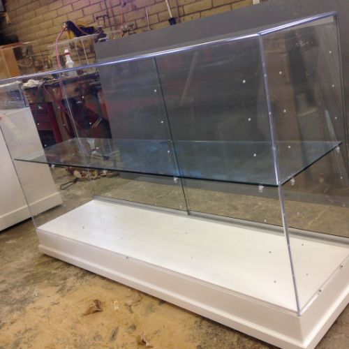 A glass display case with white base and floor.