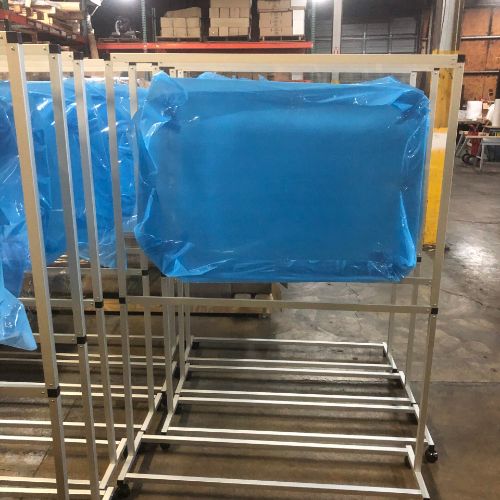 A warehouse with several racks of blue plastic bags.