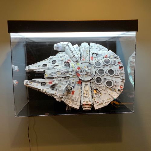 A star wars millenium falcon model in a display case.