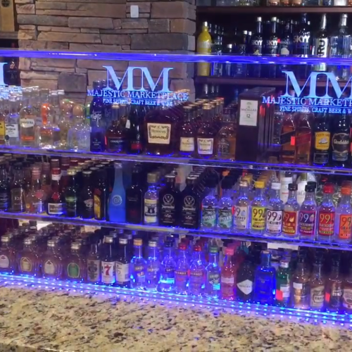 A bar with many bottles of alcohol on it