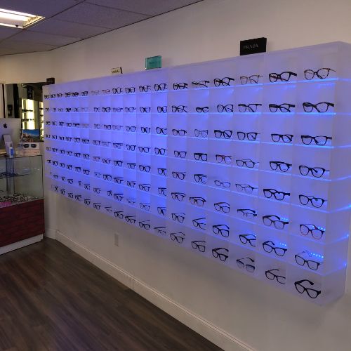 A wall of glasses in the middle of a room.