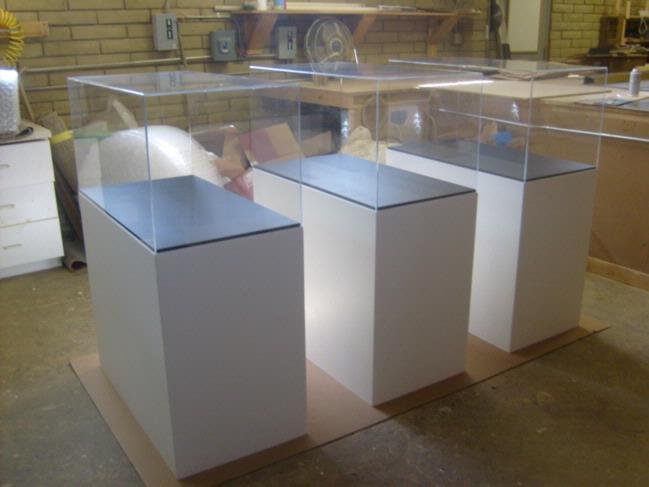 white bases pedestals A couple of white boxes with some glass on top