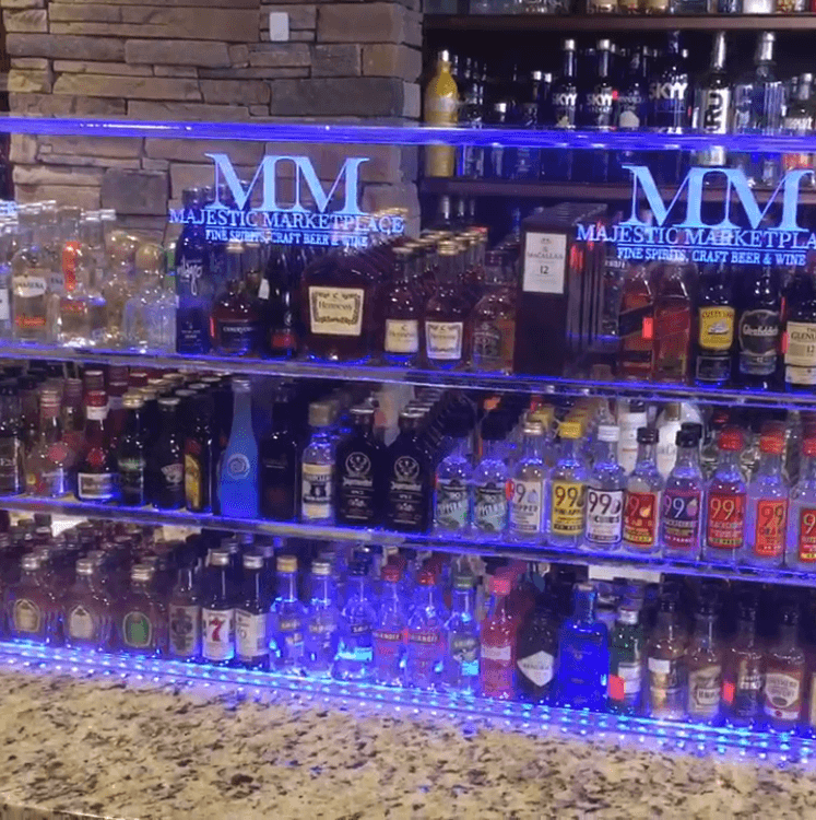 f0694df07709e8bf0eb4f42976428379 A bar with many bottles of alcohol on it